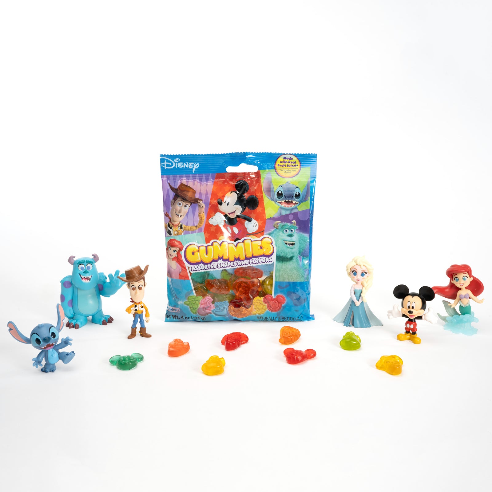 Disney gummies and toys surrounding Disney gummies bag 