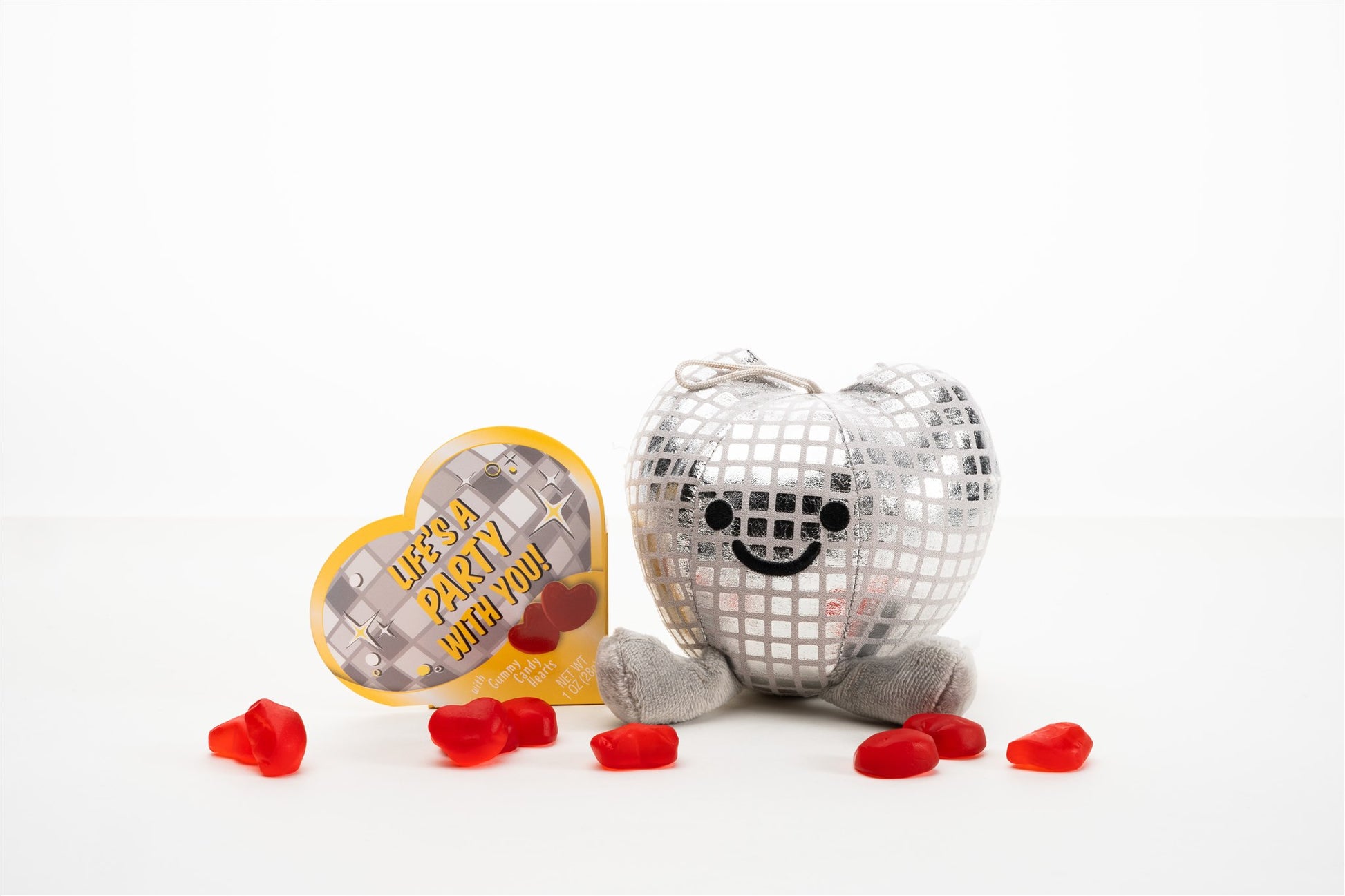 Heart shaped disco ball with heart shape box staged with gummy candy hearts 