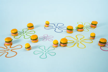 Regular and giant sized krabby patties staged with floral background 