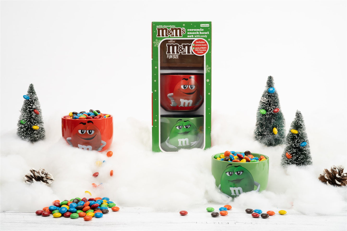 Bowl gift set staged in winter background with unboxed bowls filled with m&ms and loose m&m's scattered 