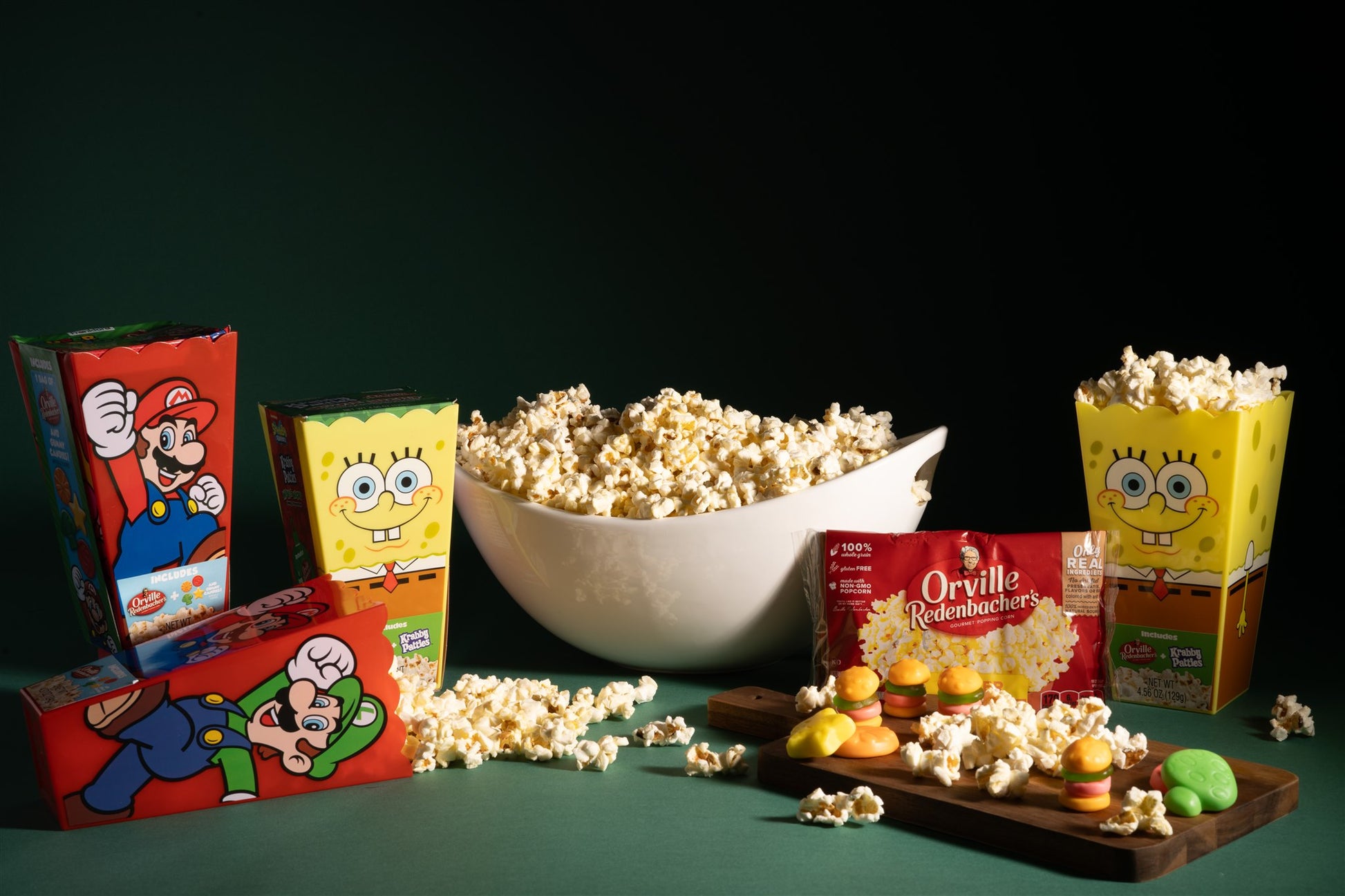 mario and spongebob sqaurepants gift sets staged with popcorn and gummies unqrapped around a bowl of popped popcorn