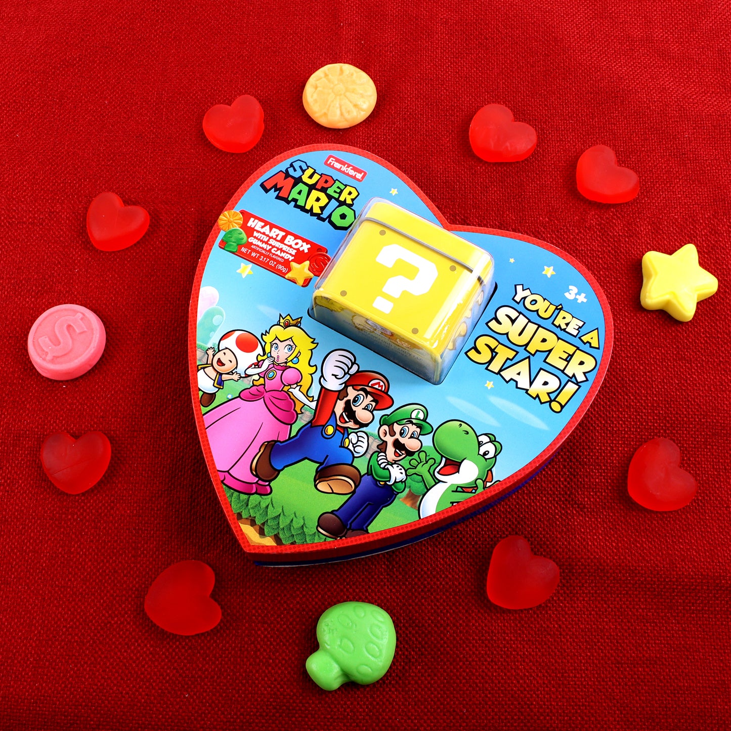 mario surprise heart box with individual unwrapped assorted gummies surrounding it 