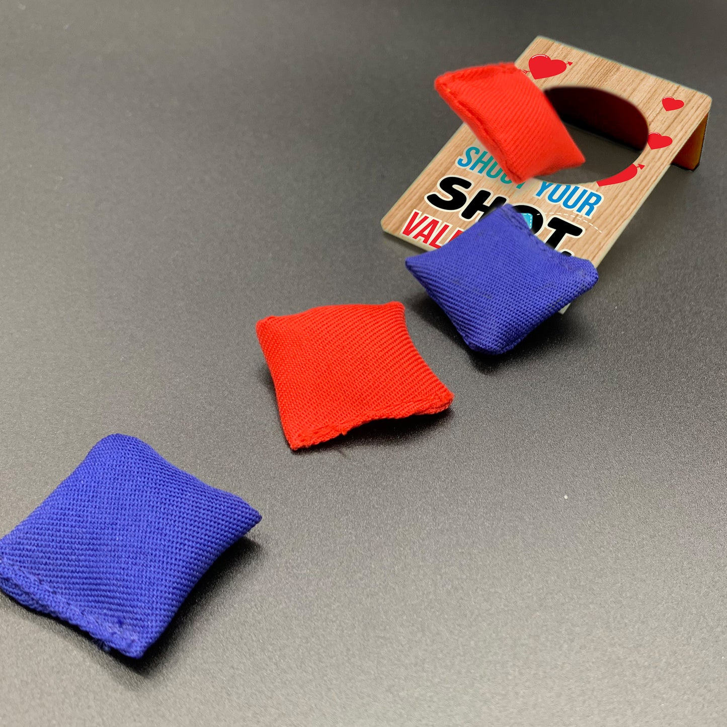 Mini corn hole set with red and blue bean bags