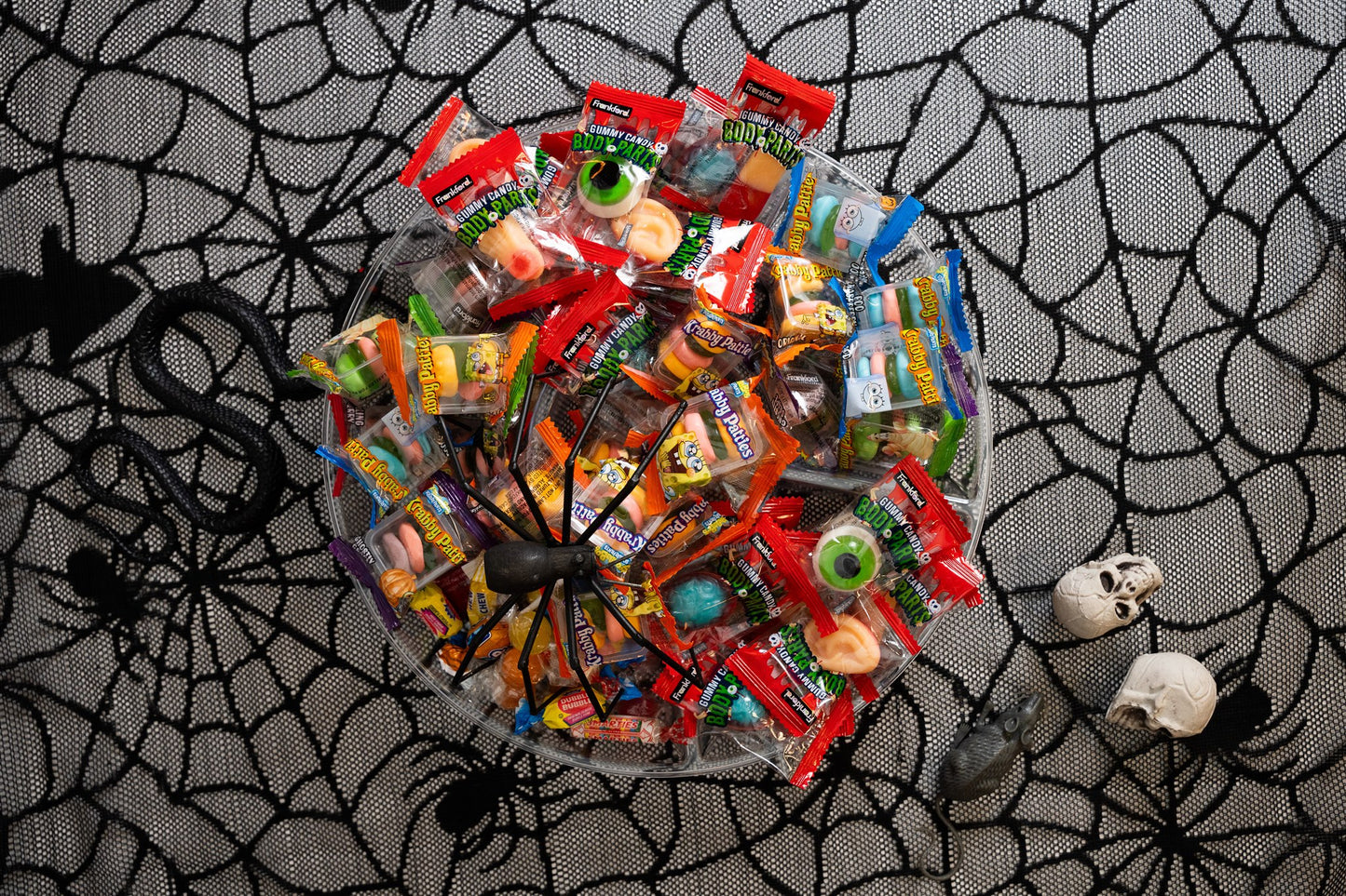 Individually wrapped gummy body parts in a bowl with other gummies(krabby patty gummies not included with gummy body parts)